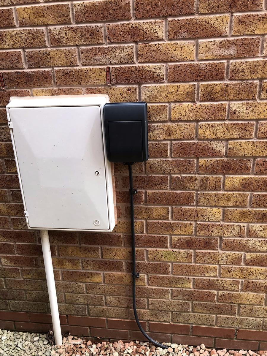 EV charger mounted next to the meter box