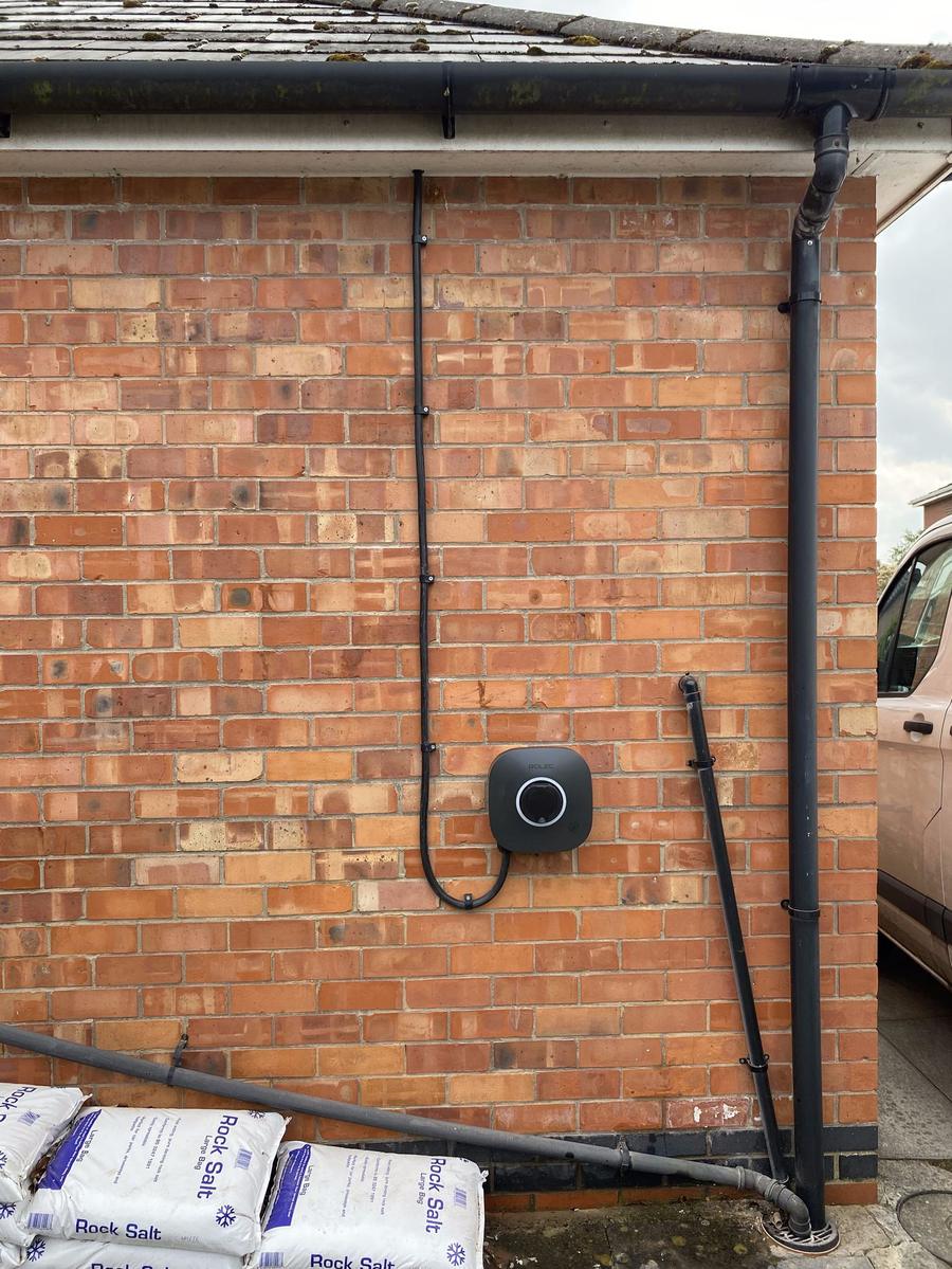 EV charger with neatly clipped cable on a side wall