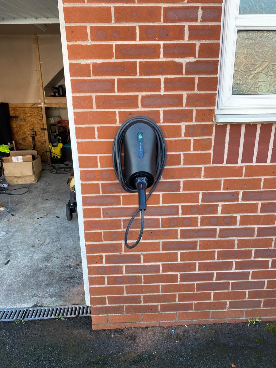 EV charger on a red brick wall